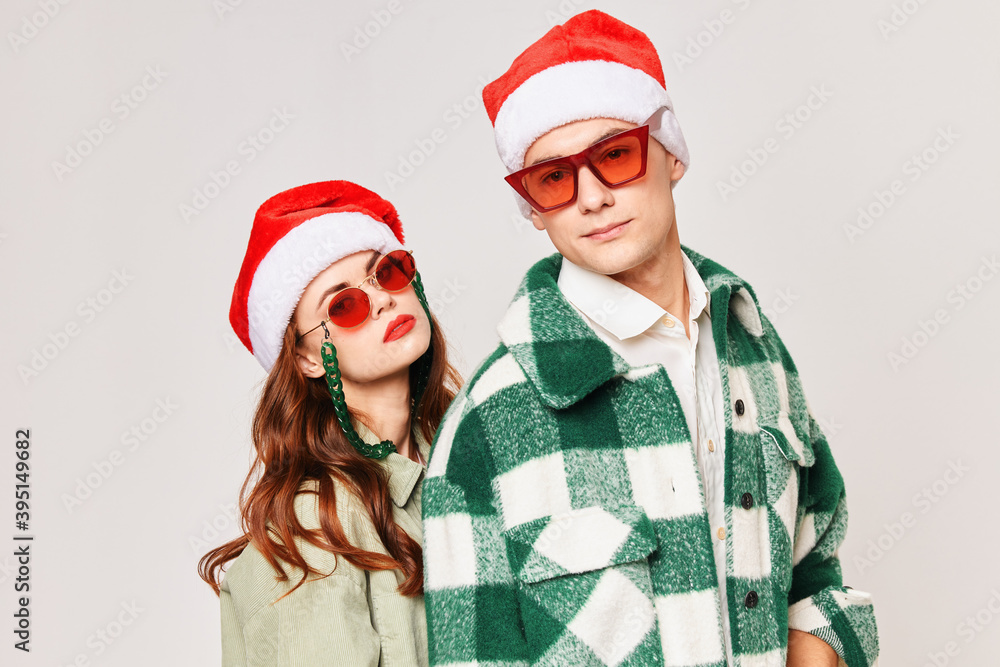 young couple wearing black glasses christmas hats together romance holiday young couple wearing black glasses christmas hats together romance holiday