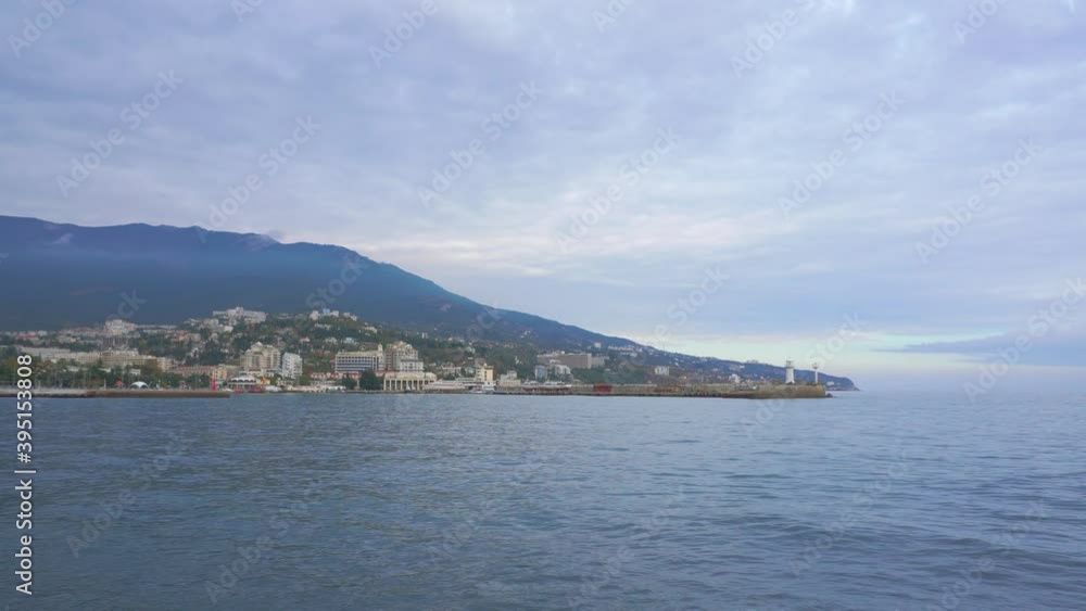 ships are in the sea against the backdrop of mountains and a beautiful blue autumn sky.. ships are in the sea against the backdrop of mountains and a beautiful blue autumn sky..