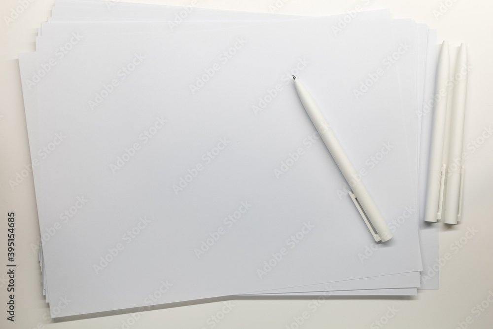 white blank paper with ball pen on table white blank paper with ball pen on table