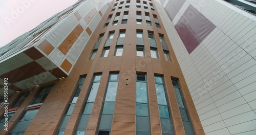 Modern new building residential building with the original design, view vertical. dolly camera shot