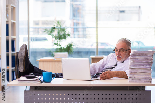 Aged businessman employee unhappy with excessive work