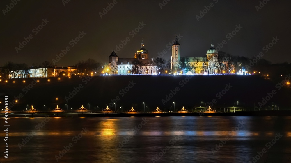 the panorama of Plock seen from the other side of the river hung at night

