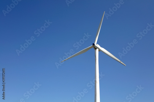 Close-up of electric windmill under clear blue sky © zhenya
