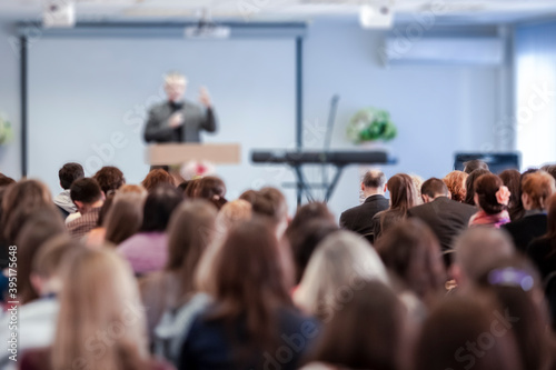 Conference Ideas. Male Lecturer Speaking In Front of the Group of People.