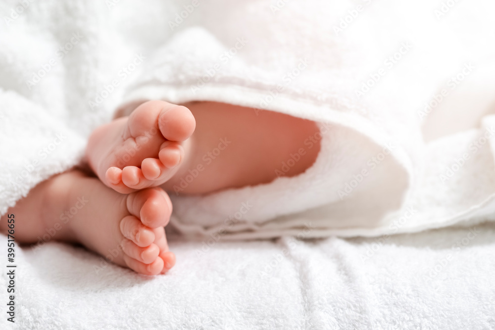 Newborn Ideas. Macro Closeup Shoot of a Four Week Old Baby Boy Feet Over Heap of White Towes. Newborn Ideas. Macro Closeup Shoot of a Four Week Old Baby Boy Feet Over Heap of White Towes.