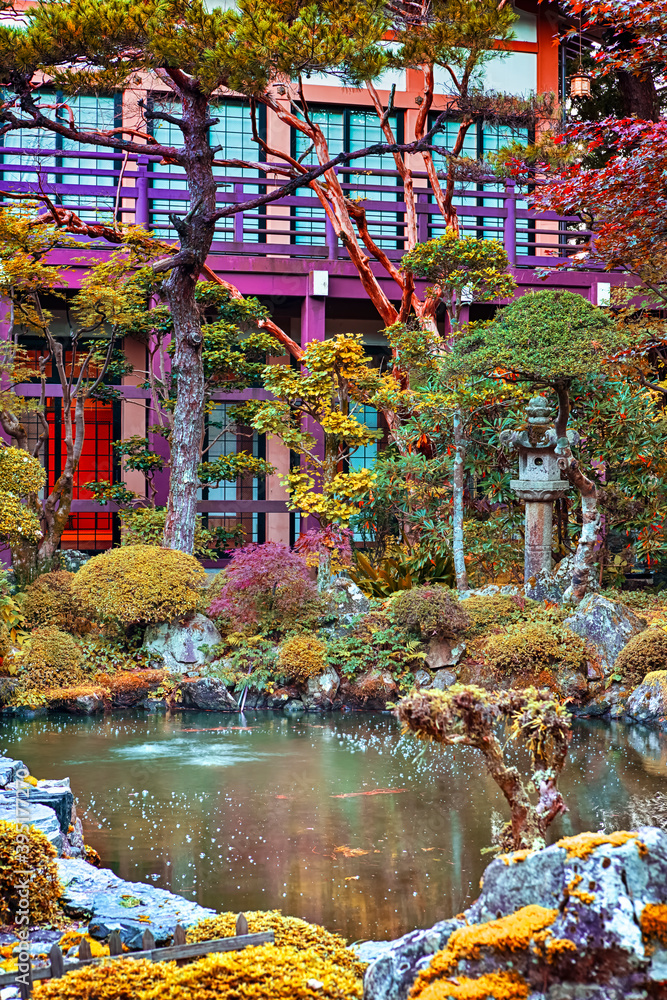 Japan Travel Concepts. Traditional japanese Garden with Red Maples, Pond and Stone Lanterns on Mount Koyasan in Japan.