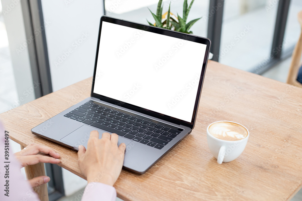 computer blank screen mockup.hand woman work using laptop with white background for advertising,contact business search information on desk at coffee shop.marketing and creative design computer blank screen mockup.hand woman work using laptop with white background for advertising,contact business search information on desk at coffee shop.marketing and creative design