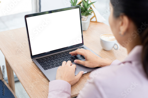 computer blank screen mockup.hand woman work using laptop with white background for advertising,contact business search information on desk at coffee shop.marketing and creative design