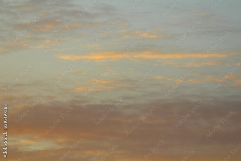 Clouds in the sky are illuminated from below by the red light of the sun. Sunset or sunrise scene at dusk