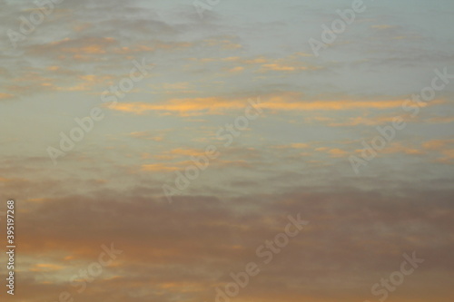 Clouds in the sky are illuminated from below by the red light of the sun. Sunset or sunrise scene at dusk © Stanislav