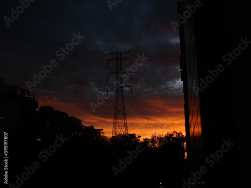 Sunset sky behind powergrid tower