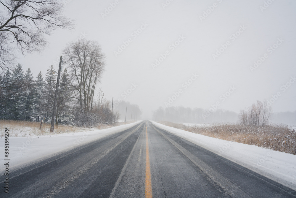 Rural Winter Roadway during Snowstorm