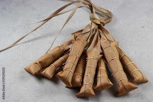 Lepet, an Indonesian food made from sticky rice wrapped in coconut leaves. photo