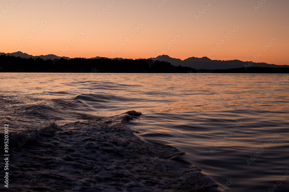Boating Wave on the Puget Sound overlooking the Olympic National Park Mountains at Sunset