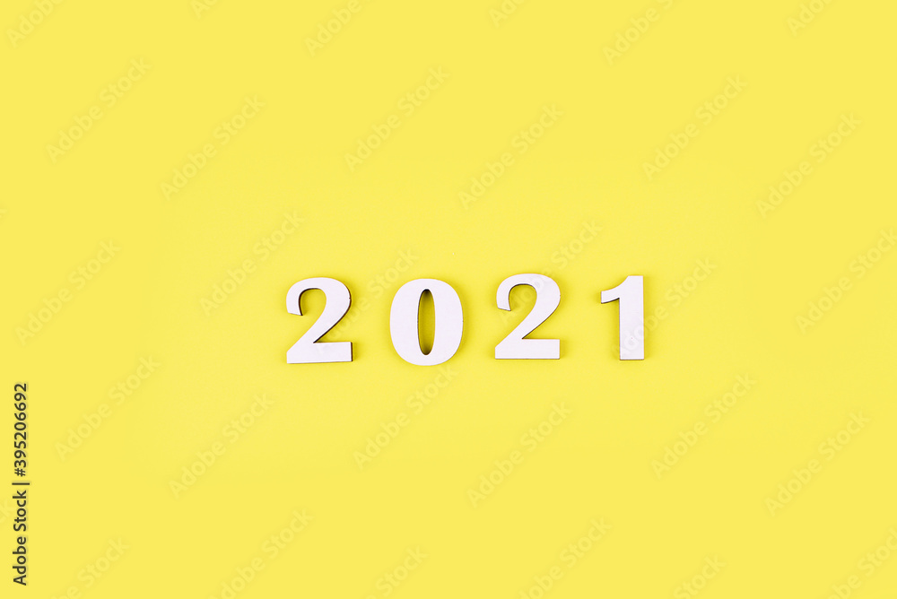 Close-up of wooden numbers 2021 on yellow background. New years content. Plase for text. Close-up of wooden numbers 2021 on yellow background. New years content. Plase for text.