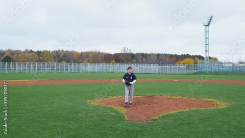 Baseball at school, the pitcher pitches fastball toward batter, boy throwing the ball.