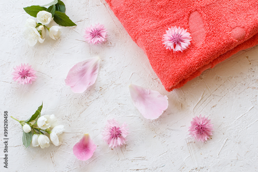 Towel and beauty flowers on a white background. Towel and beauty flowers on a white background.