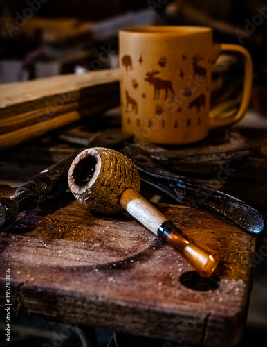 Pipe resting on a workbench. 