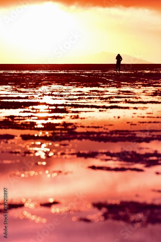 A girl walking further way in Uyuni salt lake 