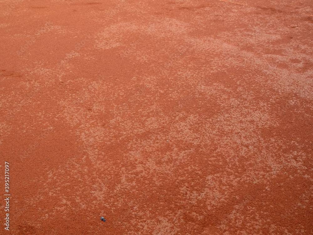 Red clay texture of tennis court. Surface of red sports field Red clay texture of tennis court. Surface of red sports field