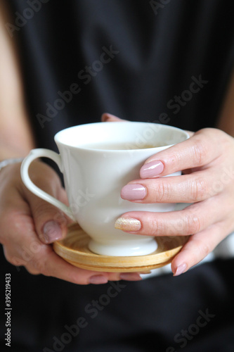 Favourite comfort drink. Morning ritual. Woman hands with cup of hot beverage.