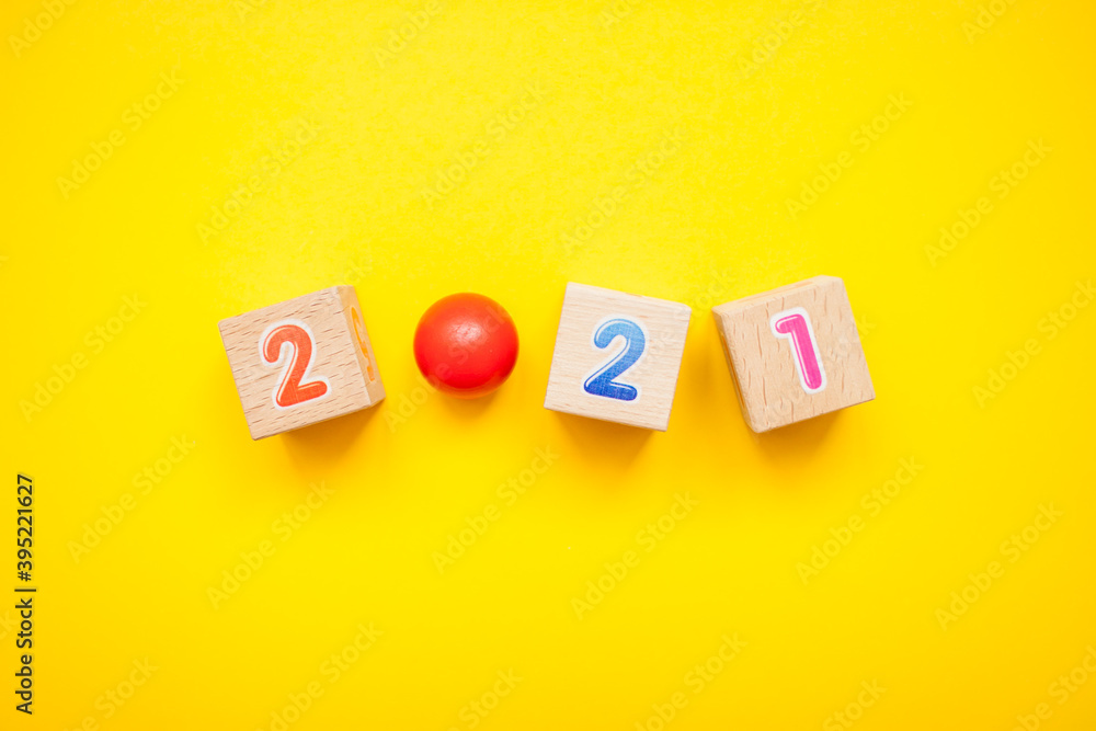 Numbers 2021 from children's cubes on a bright yellow background. New Year Christmas Numbers 2021 from children's cubes on a bright yellow background. New Year Christmas