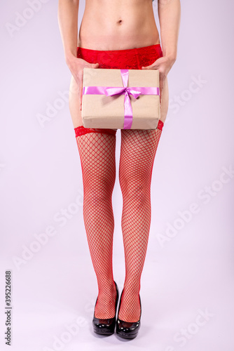 Woman in underwear and holding a gift.