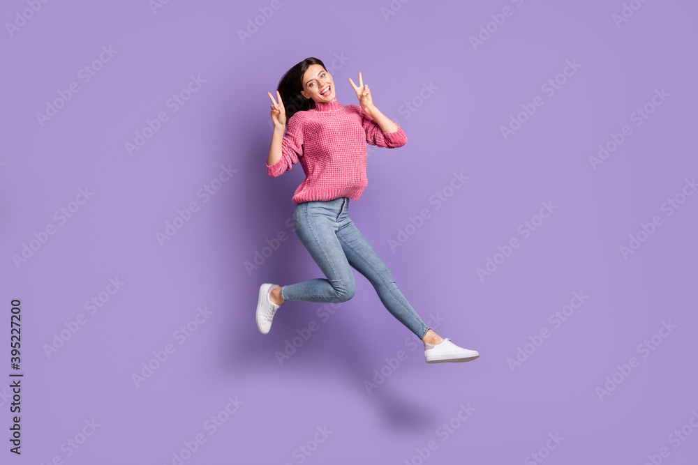 Full length body size photo of jumping high female student showing v-sign gesture isolated on bright violet color background
