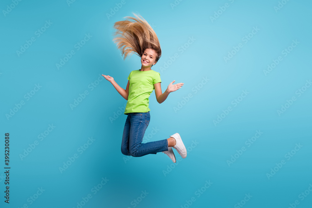 Photo portrait of funny girl jumping up isolated on pastel blue colored background Photo portrait of funny girl jumping up isolated on pastel blue colored background