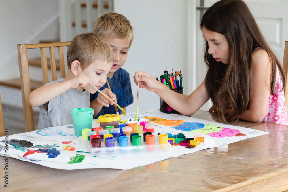 Fototapeta premium Cooperation between brothers and sister while creative process