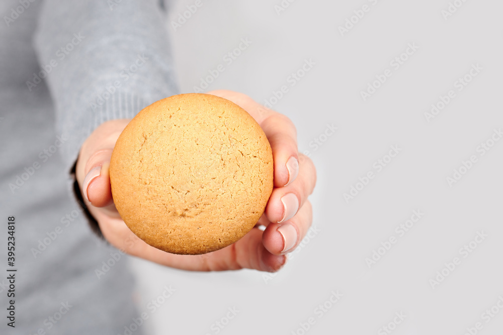 Hand with homemade cookies on grey background. Hand with homemade cookies on grey background.