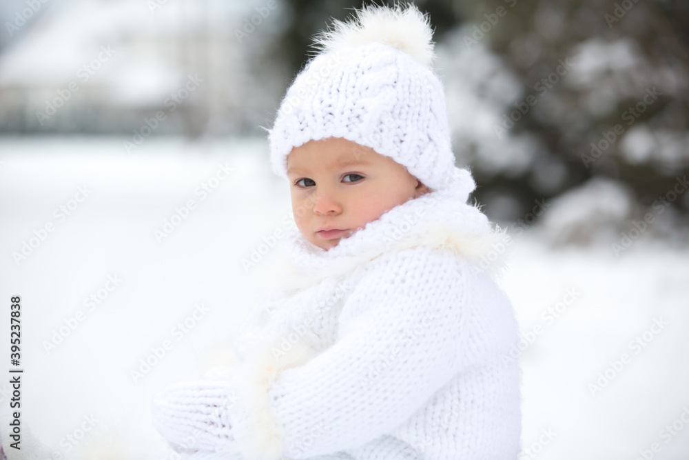 Cute little toddler boy, playing outdoors with snow on a winter day Cute little toddler boy, playing outdoors with snow on a winter day
