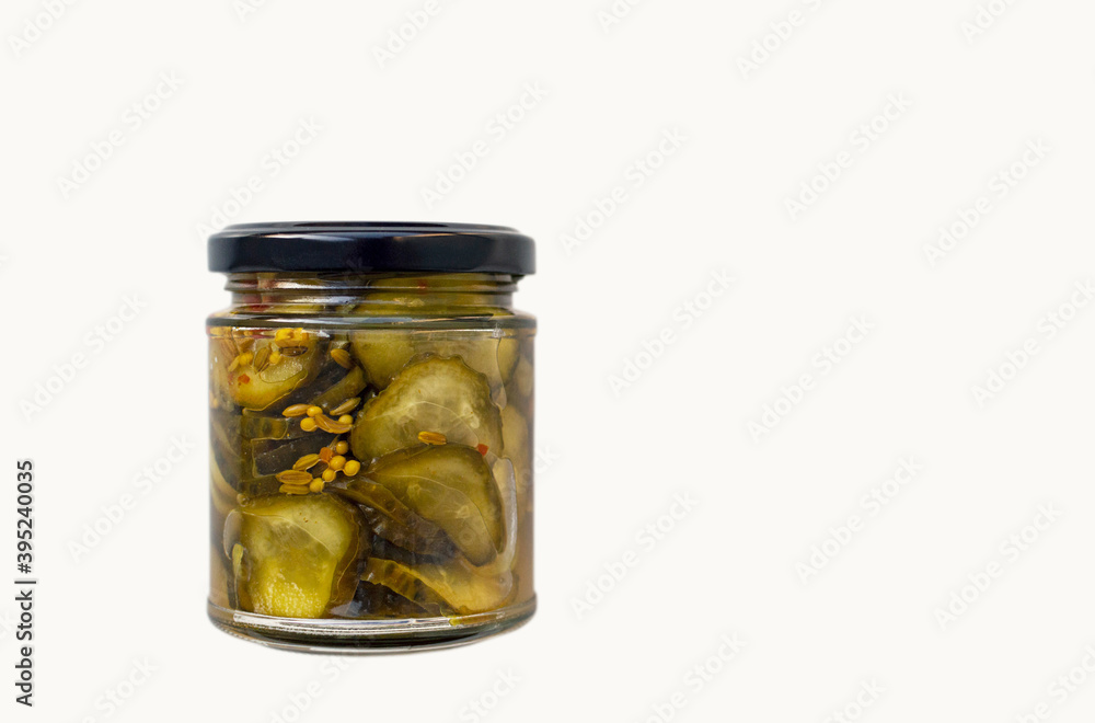 Small jar of sliced pickled cucumber isolated on white Small jar of sliced pickled cucumber isolated on white
