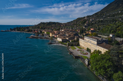 Panoramic view of the sights on Lake Garda Italy. Aerial view of architecture on Lake Garda. Ancient villa on Lake Garda in the background Alps and blue sky.