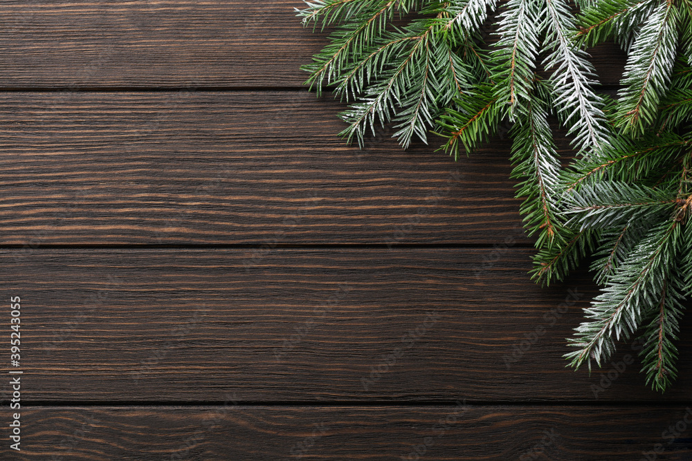 Christmas or New Year background with fir branches on a dark wooden background. Place for your text. Christmas or New Year background with fir branches on a dark wooden background. Place for your text.