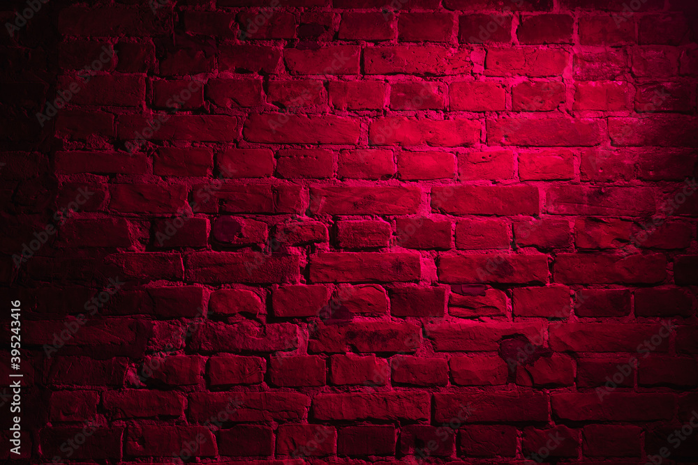 Old brick wall with bright red neon glow effect as background texture