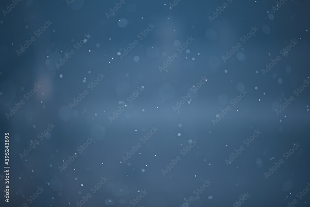 Fototapeta premium blue snowfall bokeh background, abstract snowflake background on blurred abstract blue