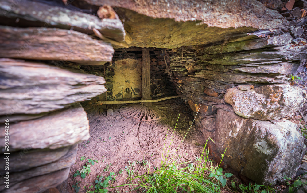 Old abandoned watermill wheel mechanism and building