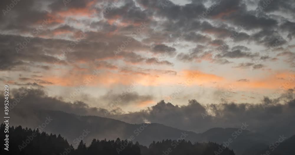 Time lapse view of dramatic sunset. Colorful clouds moving over hills. Pristine nature in the woods. Wide angle, static Time lapse view of dramatic sunset. Colorful clouds moving over hills. Pristine nature in the woods. Wide angle, static