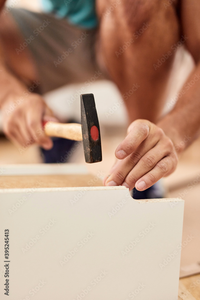 Handyman worker assembling furniture in new apartment, moving in and being hardworking. Handyman worker assembling furniture in new apartment, moving in and being hardworking.