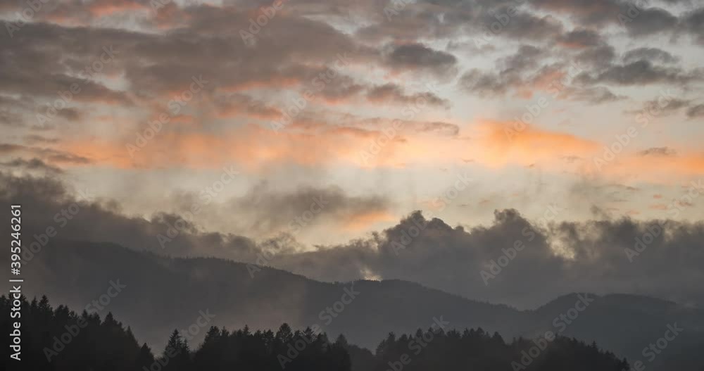 Time lapse view of dramatic sunset. Colorful clouds moving over hills. Pristine nature in the woods. Right truck parallel moving Time lapse view of dramatic sunset. Colorful clouds moving over hills. Pristine nature in the woods. Right truck parallel moving