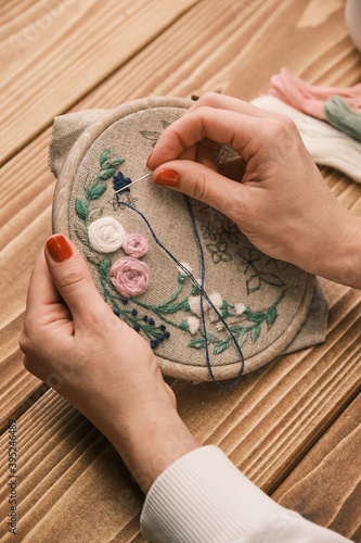 woman's hand is embroidered with tribal native fabric. Sewing pattern. Embroidery in the embroidery frame. Handmade needlework