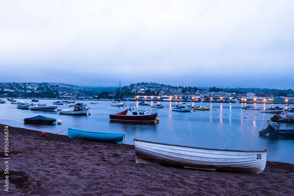 Boats moored on the Teign river in between Shaldon and Teignmouth, Devon at Dusk.