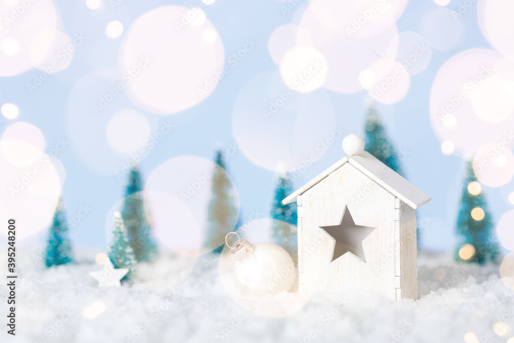 Wooden house christmas with decirations on white snow background with golden lights
