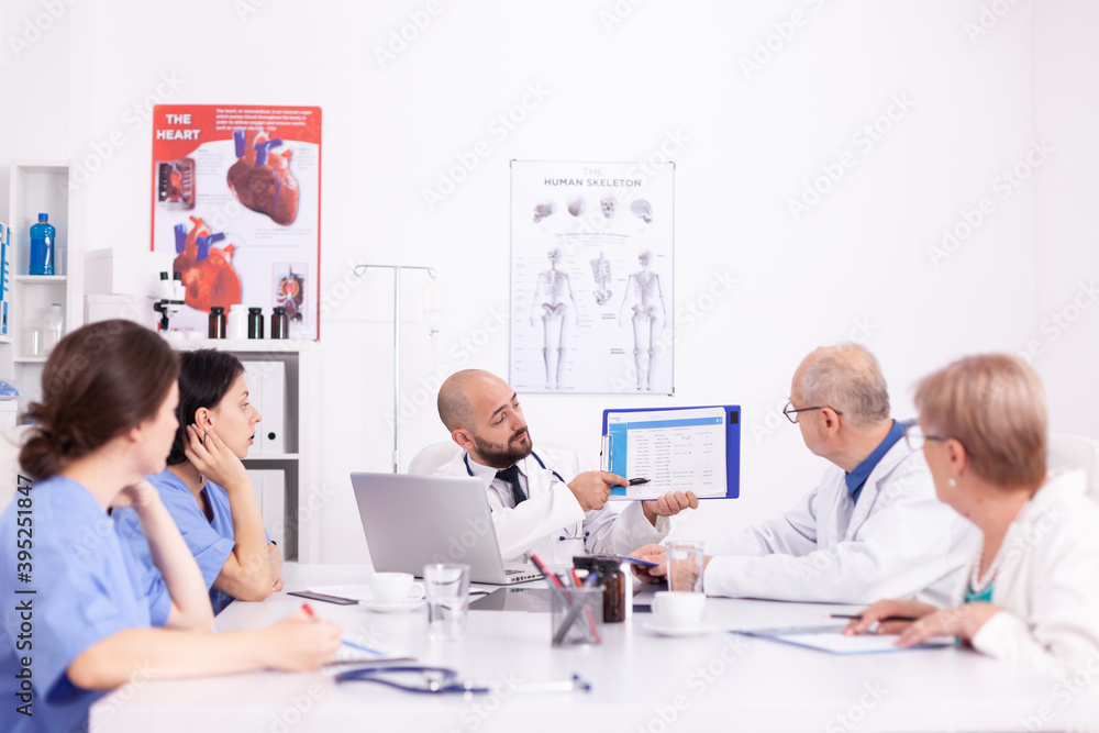 Fototapeta premium Teamwork of medical staff in hospital office talking about medicine technology. Clinic expert therapist discussing with colleagues about disease, medicine professional