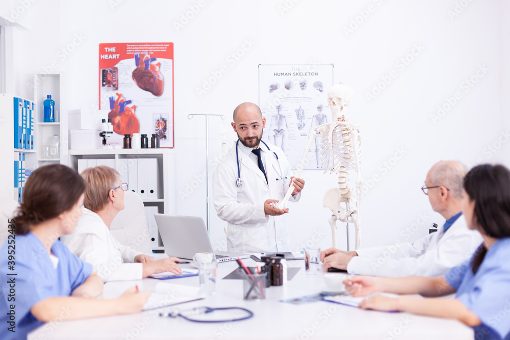 Doctor making presentation to medical staff in hospital radiology area. Clinic expert therapist talking with colleagues about disease, medicine professional Doctor making presentation to medical staff in hospital radiology area. Clinic expert therapist talking with colleagues about disease, medicine professional