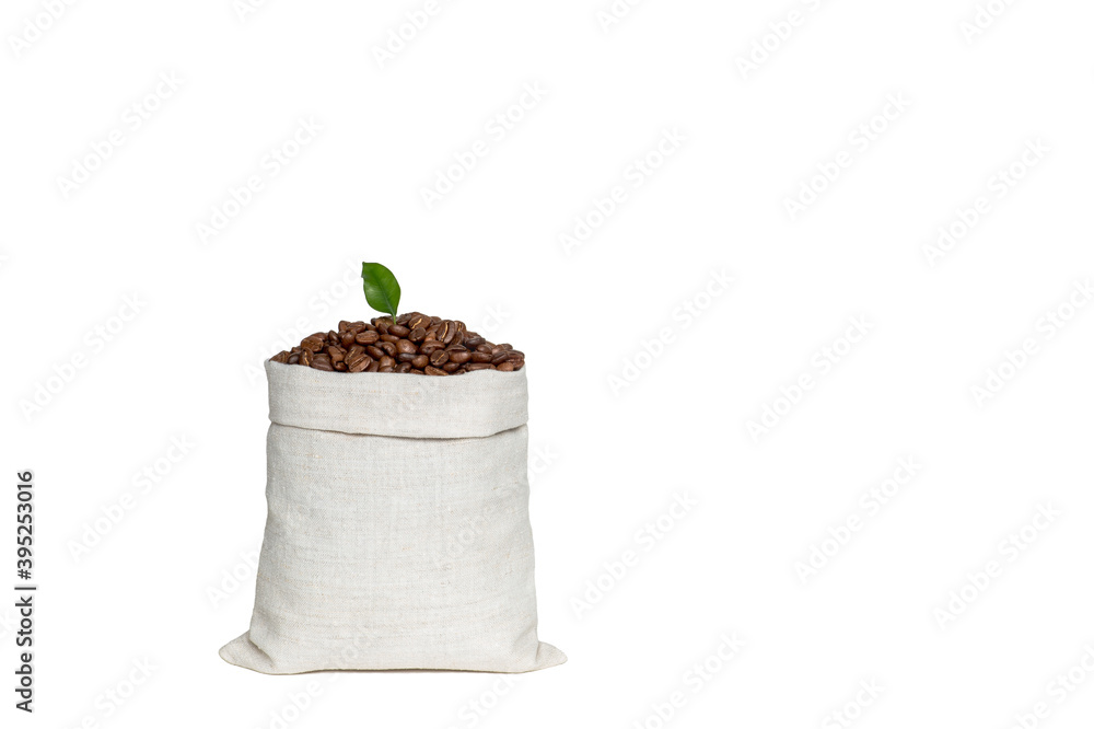 Coffee beans with a green leaf in a bag made of light linen fabric isolated on a white background Coffee beans with a green leaf in a bag made of light linen fabric isolated on a white background