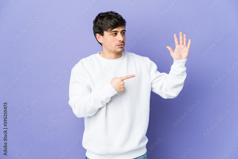 Young cool man smiling cheerful showing number five with fingers. Young cool man smiling cheerful showing number five with fingers.