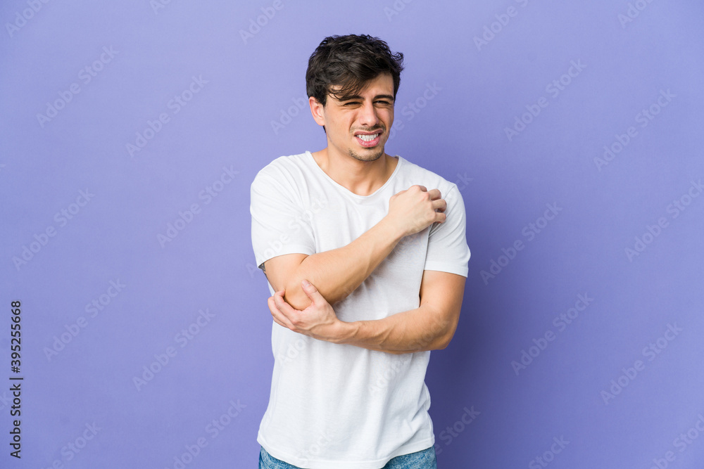 Young cool man massaging elbow, suffering after a bad movement. Young cool man massaging elbow, suffering after a bad movement.