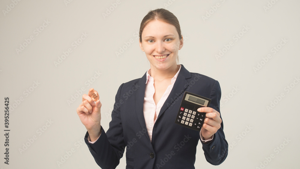 Business woman holding a physical bitcoin cryptocurrency in her hand Business woman holding a physical bitcoin cryptocurrency in her hand